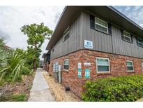 Exterior view of building with brick facade, landscaping, and address sign at 851 Miles Ave # 8, Winter Park, FL 32789