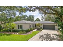 Charming single story home with mature landscaping and a gray roof at 105 Bilsdale Ct, Longwood, FL 32779