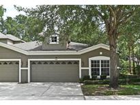 Charming home featuring a three-car garage, well-maintained landscaping, and a welcoming facade at 1086 Wickerwood St, Ocoee, FL 34761