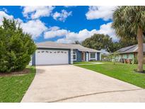 Charming single-story home featuring a well-manicured lawn and a two-car garage at 1115 Marni Ridge Ct, Kissimmee, FL 34747
