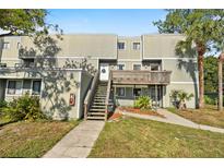 Inviting condo with a charming entrance, wooden steps and a lovely maintained yard at 126 Scottsdale Sq # 126, Winter Park, FL 32792