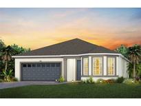 Charming single-Gathering home with a two-car garage, manicured lawn, and colorful landscaping at sunset at 1389 Zesty Citrus Ln, Minneola, FL 34715
