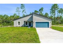 Charming single-story home featuring a modern design, manicured lawn, and a spacious two-car garage at 17301 Sw 41St Cir, Ocala, FL 34473