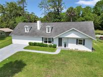 Charming home with dormer windows, gray roof, manicured lawn, and a welcoming walkway at 1836 Se 6Th Ave, Ocala, FL 34471