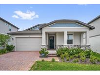 Charming single-Gathering home with a two-car garage, landscaped front yard, and welcoming entryway at 2311 Bear Peak Rd, Clermont, FL 34715
