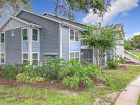 Charming two-story condo building with blue siding and well-maintained landscaping at 2580 Grassy Point Dr # 106, Lake Mary, FL 32746