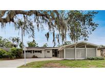 Charming single-story home with a well-maintained front yard and unique carport design at 2710 Wyndham Ln, Orlando, FL 32808