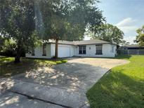 Charming single-story home with an attached garage and a concrete driveway at 337 Live Oak Blvd, Sanford, FL 32773
