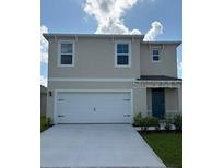 Charming two-story home with a two-car garage, well-manicured lawn, and neutral-colored facade at 3430 Briarwood Grove Dr, Ocoee, FL 34761