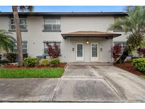 Charming townhome featuring a cozy front porch, landscaped yard, and a well-maintained exterior at 5126 Saint Charles Ln # 43, Orlando, FL 32822