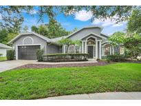 Charming single-story home featuring a lush front yard and elegant architectural details at 6609 Crenshaw Drive, Orlando, FL 32835