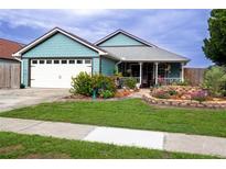 Charming single-story home with lush landscaping and a welcoming front porch at 8718 Fort Shea Ave, Orlando, FL 32822