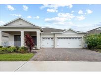 Charming single-Gathering home showcasing a three-car garage and neatly landscaped front yard at 1091 Wood Dale Cir, Oviedo, FL 32765