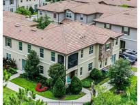 Beautiful two-story home boasts a well-manicured lawn, lush landscaping, and a charming balcony perfect for relaxation at 1391 Shinnecock Hills Dr, Davenport, FL 33896