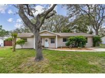 Charming single-story home with a well-maintained lawn and mature tree providing shade at 191 Ruskin St, Lake Mary, FL 32746
