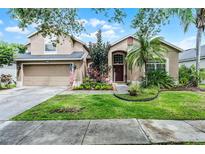 Charming two-story home with a well-maintained lawn and inviting curb appeal at 2418 Ridgemooor Dr, Orlando, FL 32828