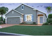 Charming single-story home featuring a stone-accented entry, a two-car garage, and a well-manicured lawn at 2642 Great Heron Ave, St Cloud, FL 34773