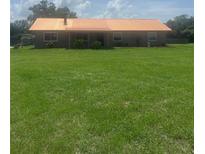 Charming single-story home featuring a lovely brick facade and a sprawling green lawn at 4160 Packard Avenue, St Cloud, FL 34772