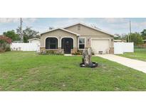 Charming home with well-manicured lawn, stone accents, and an attached one-car garage at 1078 Aaron Dr, Deltona, FL 32725