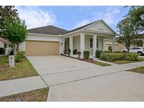 Charming single Gathering home showcasing a well-manicured lawn and a beige two-car garage at 12679 Calderdale Ave, Windermere, FL 34786