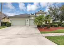 Charming one-story home featuring a three-car garage and well-manicured landscaping at 14319 Islamorada Dr, Orlando, FL 32837