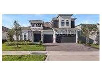Beautiful two-story home with stone accents, manicured lawn, and a three-car garage at 4413 Lions Gate Ave, Clermont, FL 34711