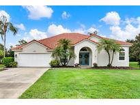 Charming single-story home featuring a red tile roof, attached garage and a beautifully manicured lawn at 6321 Clearmeadow Ct, Windermere, FL 34786