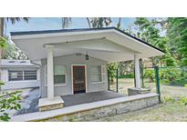 Inviting covered front porch with sturdy columns and freshly painted exterior offers curb appeal at 637 15Th St, Debary, FL 32713