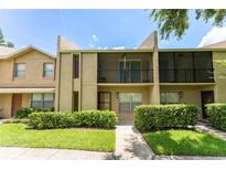 Attractive condo with tan exterior, well-manicured lawn, and screened in porch at 818 Park Lake Cir # 10, Maitland, FL 32751