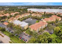 Stunning aerial view of a lakeside apartment complex with well-manicured landscaping and a central water feature at 1400 Lake Shadow Cir # 10104, Maitland, FL 32751