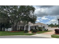 Well maintained single story home with manicured lawn, mature trees, and ample curb appeal at 1586 Antoinette Ct, Oviedo, FL 32765