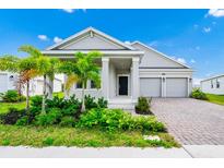 Charming single-story home with a well-manicured lawn, lush landscaping, and a two-car garage at 1596 Contentment Loop, Kissimmee, FL 34744