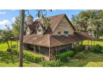 Charming two-story home with a screened-in porch and meticulously landscaped front yard, perfect for relaxation at 17952 Lookout Hill Rd, Winter Garden, FL 34787