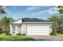Charming single-story home showcasing a modern design with a two-car garage and a well-manicured lawn at 1916 Diamond Head Cir, Lake Hamilton, FL 33851