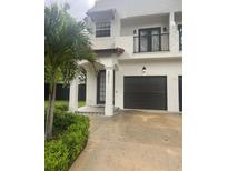 Charming two-story home with a well-manicured lawn and a private two-car garage at 2011 E Esther St, Orlando, FL 32806