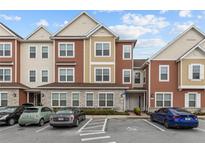 Charming townhome exterior with colorful facades and convenient parking in a well-maintained community at 2630 Sunrise Shores Dr, Kissimmee, FL 34747