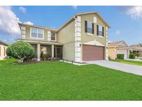 Charming two-story home featuring a two-car garage, a screened-in porch, and a well-maintained lawn at 2657 Bullion Loop, Sanford, FL 32771