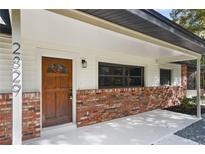 Inviting front door and brick exterior, creating a warm welcome to this charming home at 2829 Lake Griffin Rd, Lady Lake, FL 32159