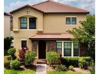Charming two-story home with manicured lawn and a beautiful tiled roof, offering curb appeal at 312 Partridge Pea Ln, Ocoee, FL 34761
