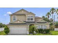 Charming two-story home with a two-car garage and well-maintained landscaping at 3222 Eagle Creek Ln, Kissimmee, FL 34746