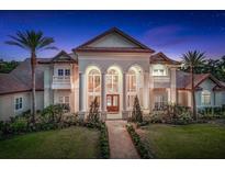 Elegant exterior showcasing grand architecture, lush landscaping, and a pathway leading to the entrance at 3461 Michigan St, Lake Mary, FL 32746