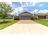 Charming single-story home with a two-car garage, stone accents, and landscaped front yard at 3651 Nw 56Th Ave, Ocala, FL 34482