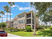Condo exterior with two screened patios, palm trees, and well-kept landscaping at 8168 Boat Hook Loop # 201/718, Windermere, FL 34786
