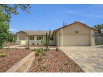 Charming single-story home with well-maintained landscaping and inviting curb appeal at 9319 Woodbreeze Blvd, Windermere, FL 34786