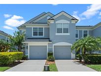 Charming two-story townhouse with attached garages, lush landscaping, and beautiful curb appeal at 934 Rock Harbor Ave, Orlando, FL 32828