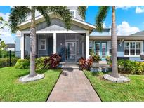 Beautiful home exterior with lush landscaping, walkway and screened in front porch at 14366 Walcott Ave, Orlando, FL 32827