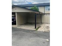 Attached carport with space for parking, providing convenient covered access to the home at 1815 Townhall Ln # 1815, Orlando, FL 32807