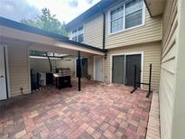 Paver patio with built-in grill and covered entertaining space at 1815 Townhall Ln # 1815, Orlando, FL 32807