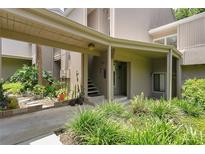 Inviting entrance with covered parking and lush landscaping enhances this home's curb appeal at 2142 Woodbridge Rd, Longwood, FL 32779