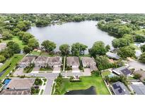 Stunning aerial view of lakeside community featuring beautiful homes, lush trees, and tranquil waters at 2922 Reef Knot Pl, Winter Park, FL 32792